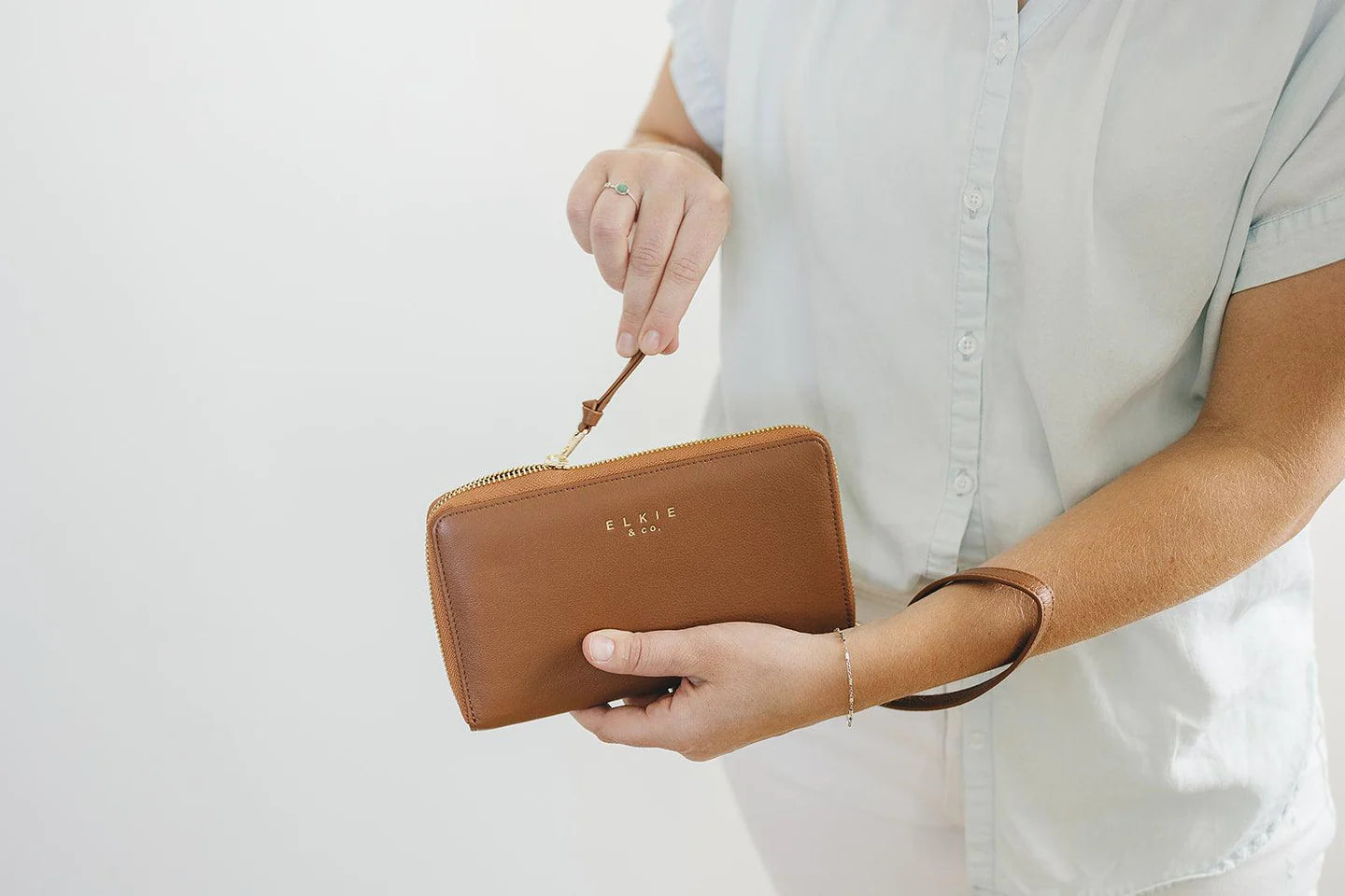 pouches and wallets. tan leather wallet. zipper closure. 