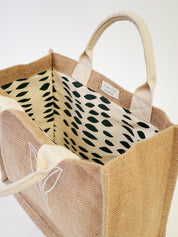 Jute Market Bag. Reusable. Leaf Patter Print. Approximately10” tall x 12.5” wide x 6" deep. Canvas lining with cotton. Colors Natural, White, Green.