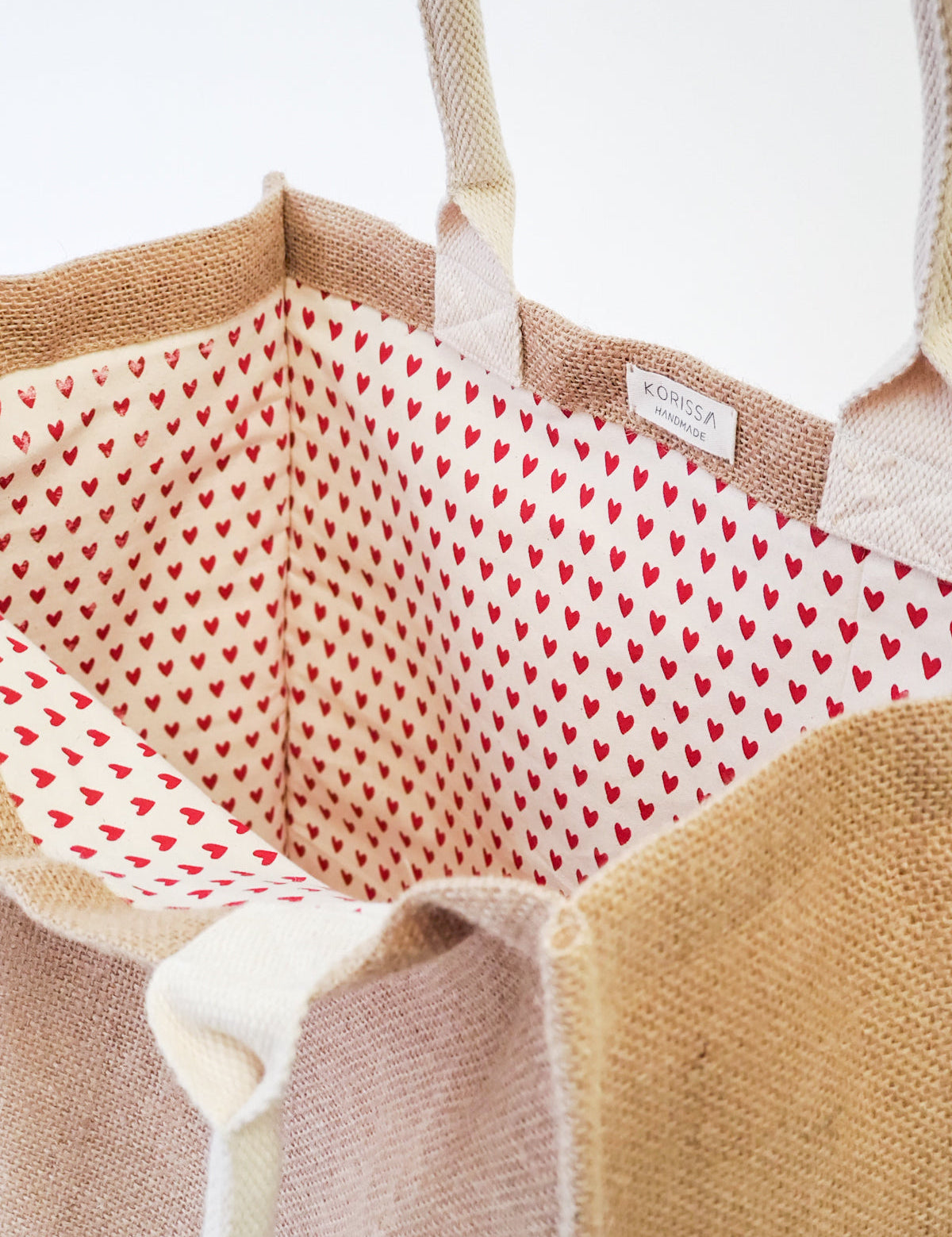 handmade tote bag. market tote. heart print. jute canvas material. 16” tall x 15” wide x 9" deep.  