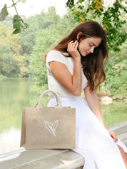 Jute Market Bag. Reusable. Leaf Patter Print. Approximately10” tall x 12.5” wide x 6" deep. Canvas lining with cotton. Colors Natural, White, Green.