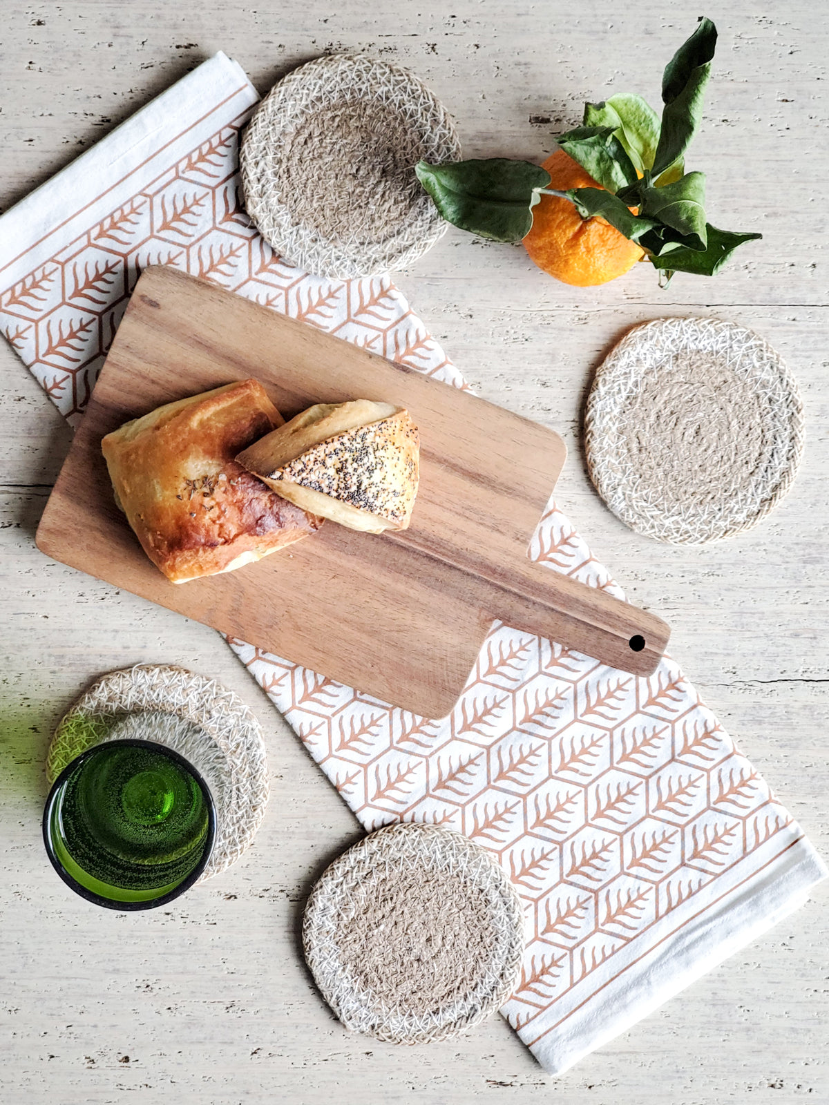 Approximately 4” round. sustainably handmade. braided jute. round drink coasters.  natural with white.